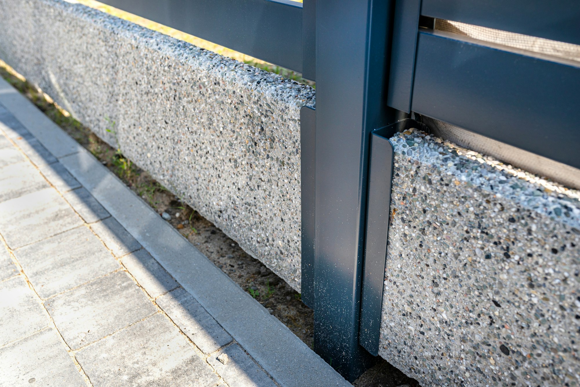 modern panel fencing in anthracite color, visible connector of the fence foundation.